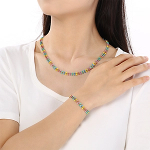 Close-up of colorful heart-shaped charms on a gold chain necklace and bracelet set