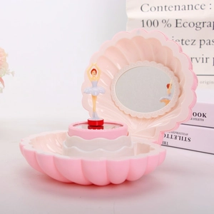 Detail view of pink shell music box with interior mirror and spinning ballerina