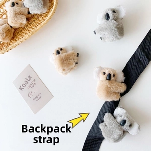 Detailed view of cute plush koala hair clips in grey and tan with soft fuzzy texture