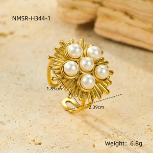 Macro detail of gold stainless steel flower ring with white pearls and 6.8g weight