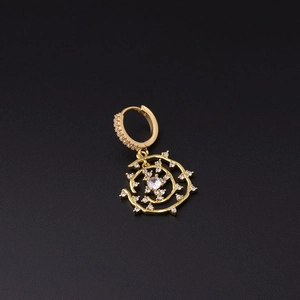 Detailed view of a gold micro-set earring with sparkling crystals and spiral charm