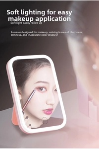Detail of pink LED makeup mirror with touch control and portable folding stand design