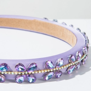 Close-up of lavender baroque headband with water-drop crystals and golden chain