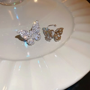 Detail of silver butterfly earrings with sparkling cubic zirconia on ceramic tray