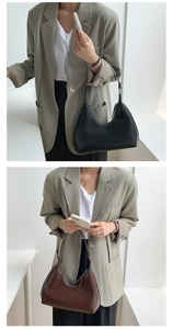 Close-up of minimalist hobo bags in black and dark brown PU leather finish