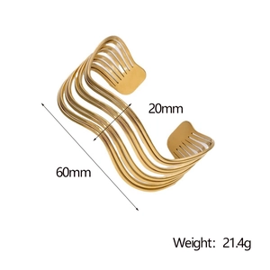 Detail view of gold-plated wavy cuff bracelet with 20mm width and 21.4g weight
