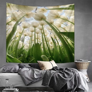 Detail of white tulip wall tapestry hanging above a bed in a modern bedroom interior