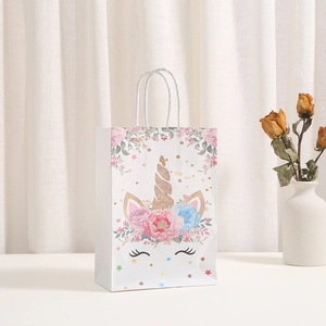 Elegant white unicorn party gift bag with gold foil patterns and white rope handles