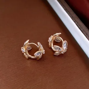 French vintage gold flower earrings with sparkling marquise crystals on a textured base