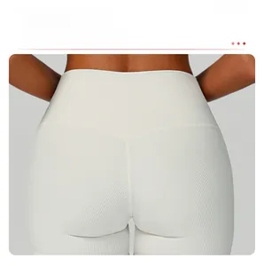 Detailed view of the V-shaped seam design and ribbed texture on white high waist gym shorts