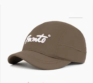 Detail of coffee brown quick-dry fabric with white 3D embroidery on the five-panel cap