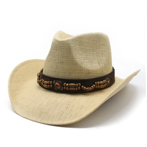 Classic straw cowboy hat with bohemian beaded band and vintage metal ornament