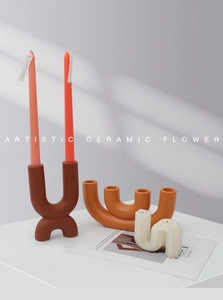 Close-up of artistic ceramic candle holder with modern wave shapes and matte finish