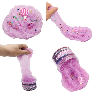 Macro views of purple slushie slime with star sequins and a hot air balloon charm