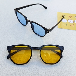 Close-up of classic retro sunglasses with blue and yellow lenses and silver metal details