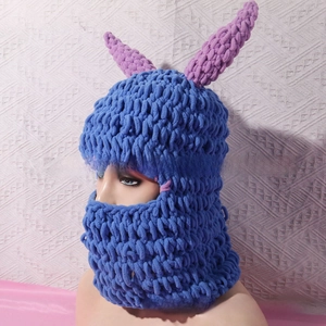 Close-up of handmade crochet balaclava featuring vibrant blue knit and purple bunny ears
