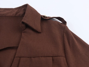 Detail view of cotton-linen utility dress shoulder with epaulette and gold button