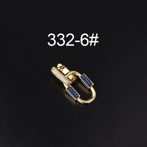 Macro detail of gold plated earring clasp with inlaid blue and clear zircon crystals