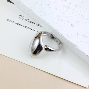 Polished silver stainless steel open ring with irregular water drop shape on stone base