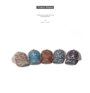 Detail of five printed trucker hats with mesh back and various ethnic floral patterns