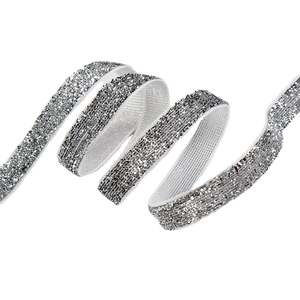 Glittery silver ribbon roll with 1cm width and textured metallic finish on white background