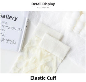 Detail display showing the elastic ribbed cuff and heart jacquard pattern of the socks