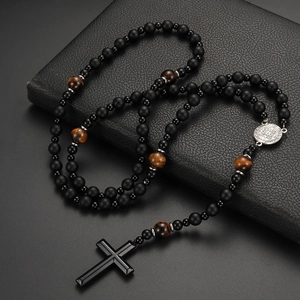 Macro detail of men's religious rosary necklace with lava stones and cross pendant