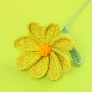 Handmade crochet yellow cosmos flower with orange center and single green leaf