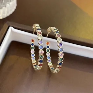 Luxury gold C-shape hoop earrings with colorful zircon stones in a rainbow pattern