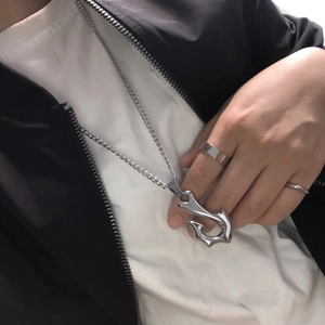 Punk silver stainless steel necklace with fish hook pendant on person with casual style
