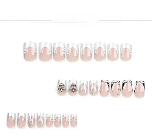 Detailed view of square press-on nails with silver flame patterns and 3D metal cross decor