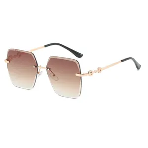 Fashion rimless oversized sunglasses with brown gradient lenses and gold metal chain temples