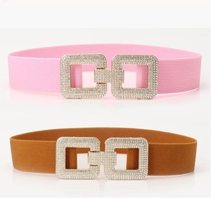 Close-up of pink and brown elastic waist belts with interlocking diamond buckles