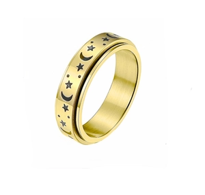 Detail of gold rotating ring featuring brushed finish and engraved star and moon patterns