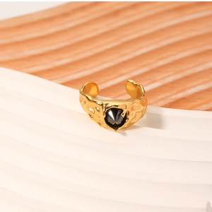 Macro detail of vintage gold open ring with lava texture and black zircon stone
