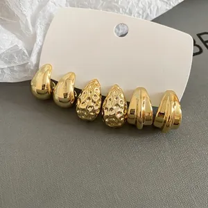 Three-pair gold twist stud earrings set featuring smooth, hammered, and ribbed textures