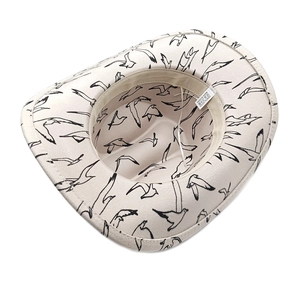 Detail view of polyester fedora interior with camouflage bird print and adjustable strap