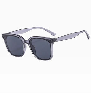 Detail of gray purple square sunglasses showing polished frame and UV protection lens