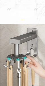 Detail of 360-degree rotating silver wall hook rack with kitchen utensils hanging on it