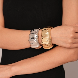 Irregular wide metallic cuff bracelet with wavy fold texture in gold and silver finish