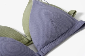 Detailed macro shot of ribbed knit fabric texture and premium stitching on triangle bra