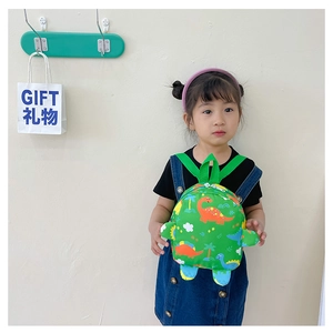 Detail showing the adjustable straps and colorful dinosaur patterns on the kids backpack