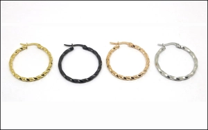Detail of twisted hoop earrings in gold, black, rose gold, and silver finishes