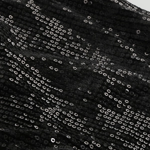 Close-up of high-density black sequins on fabric showing shimmering texture and detail