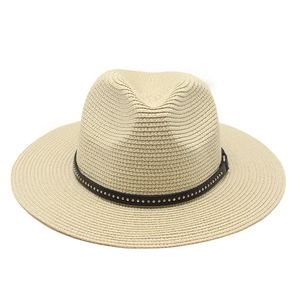 Close-up of beige straw jazz hat featuring a black leather band with metallic stud details