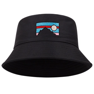 Detailed close-up of mountain sunrise embroidery on a black cotton canvas bucket hat