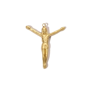 Macro detail of a 14k gold-plated stainless steel crucifix cross charm with polished finish