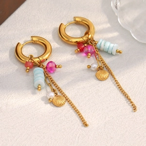 Detailed shot of 18K gold plated hoop earrings with colorful beads and shell charm