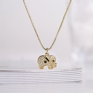 Macro shot of gold-plated elephant pendant with pavé zircons and detailed box chain