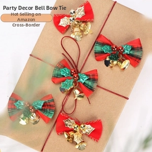 Close-up of festive red and green plaid Christmas bows with golden bells on gift box